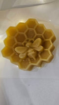 Three silicone molds shaped like a flower, butterfly, and leaf on a white background.