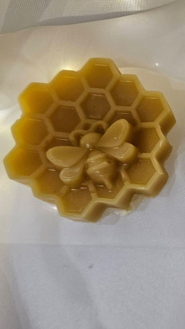 Three silicone molds shaped like a flower, butterfly, and leaf on a white background.